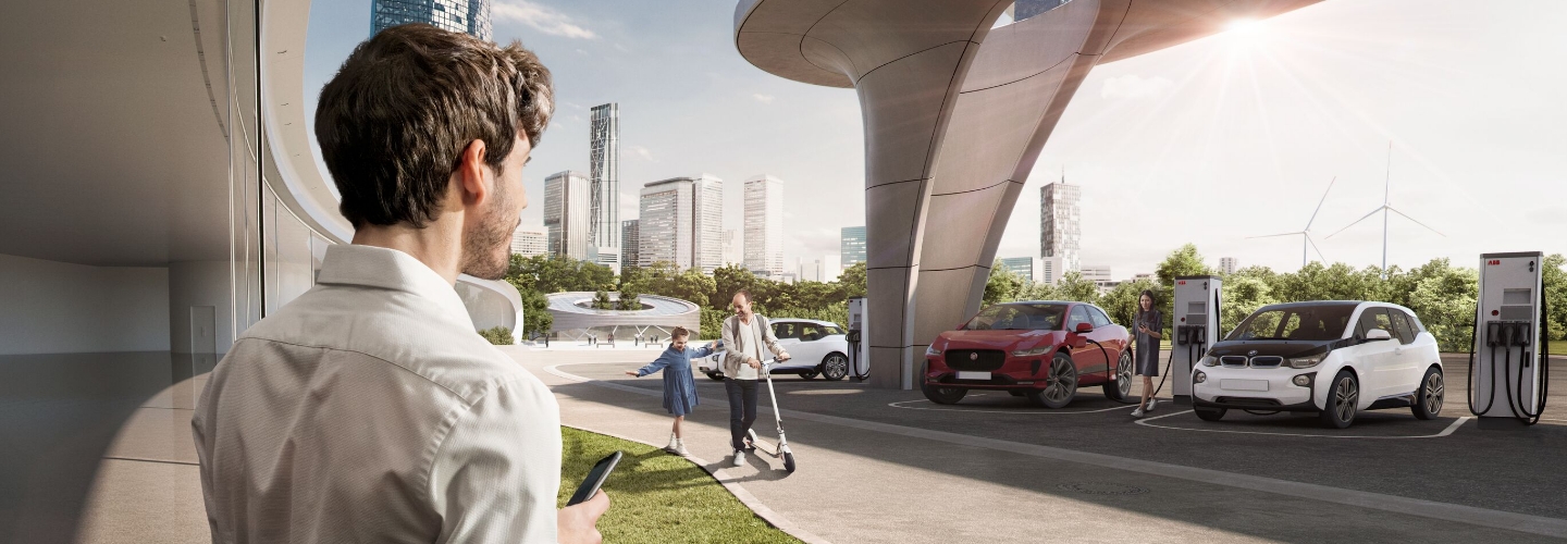 Man looking at the ABB charging station in a futuristic environment