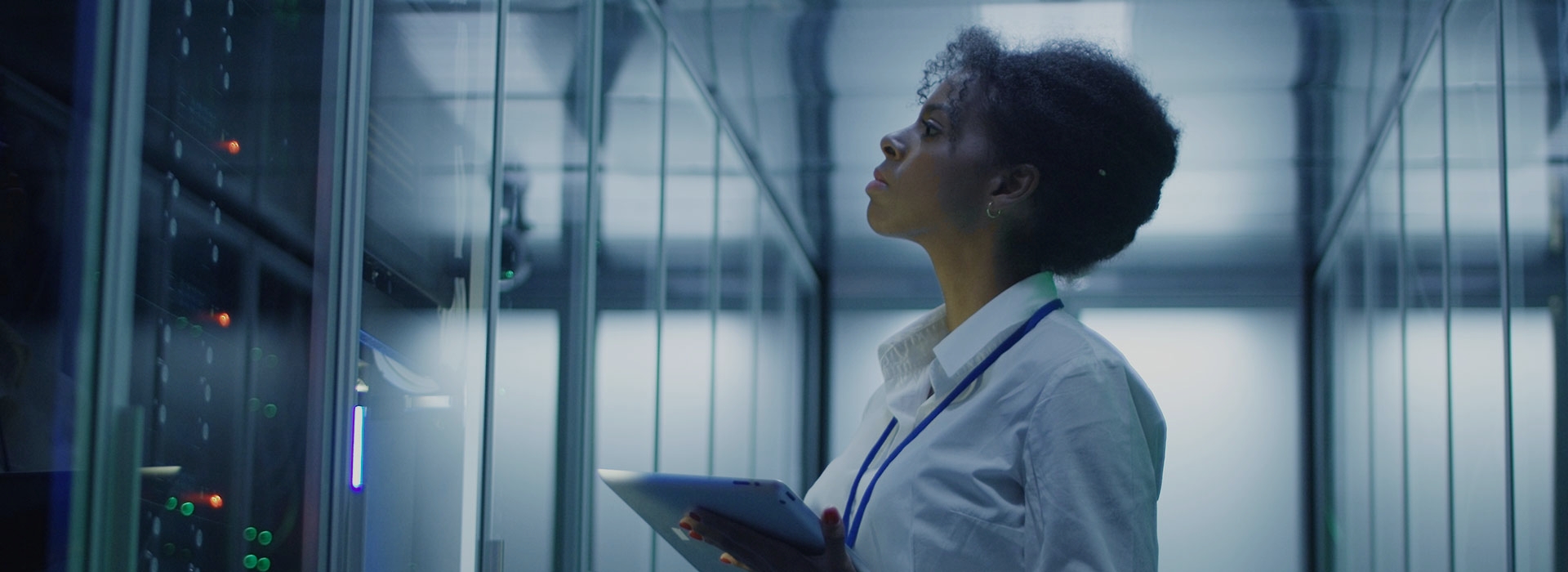 Woman checking devices in a server room