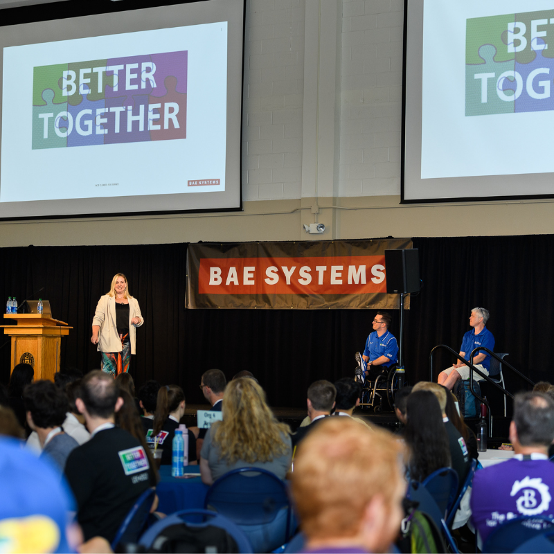 BAE Systems Chief Diversity Officer, Dana Rixter, and representatives from Northeast Passage, a non-profit organization empowering individuals with disabilities presenting on stage to LDP participants on the importance of inclusivity at the 2022 Leadership Development Conference.