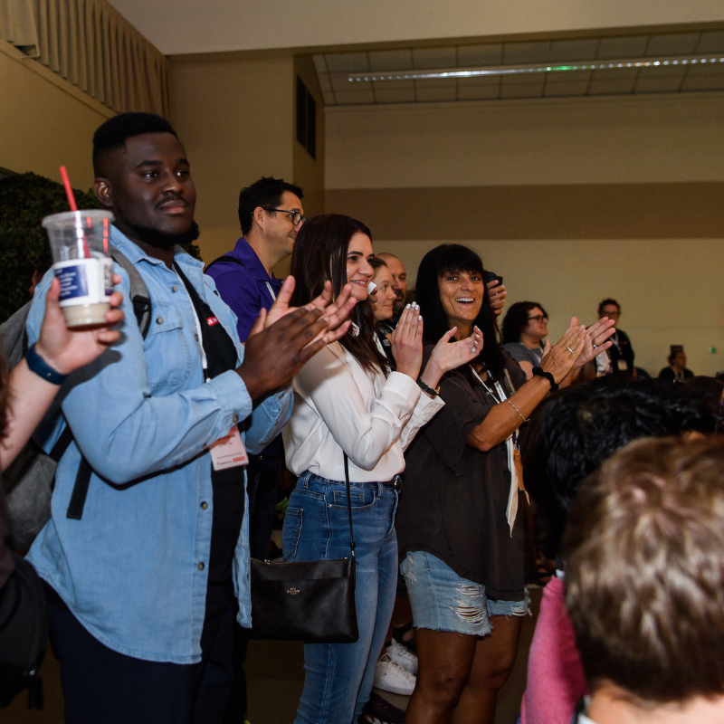 Paapa (Quality Assurance LDP, left), Maria (Engineering Director, center), cheer as they watch the developmental lab competition. 