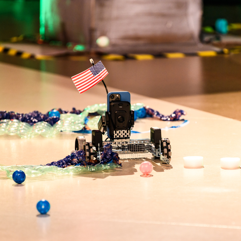 A rover collecting plastic balls to win points for its team. 