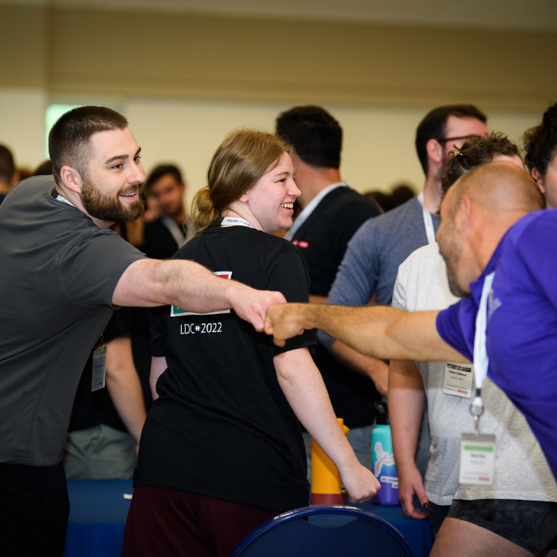 A Brown Center representative fist bumping a BAE Systems Leadership Development Program member.