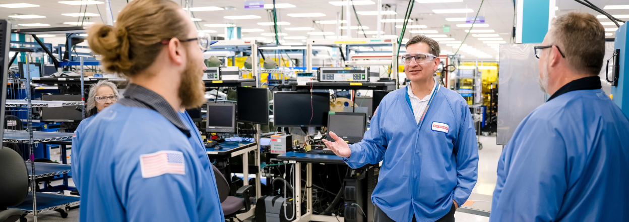 Richard, an engineering industrial manager, speaks to his team on the manufacturing floor.