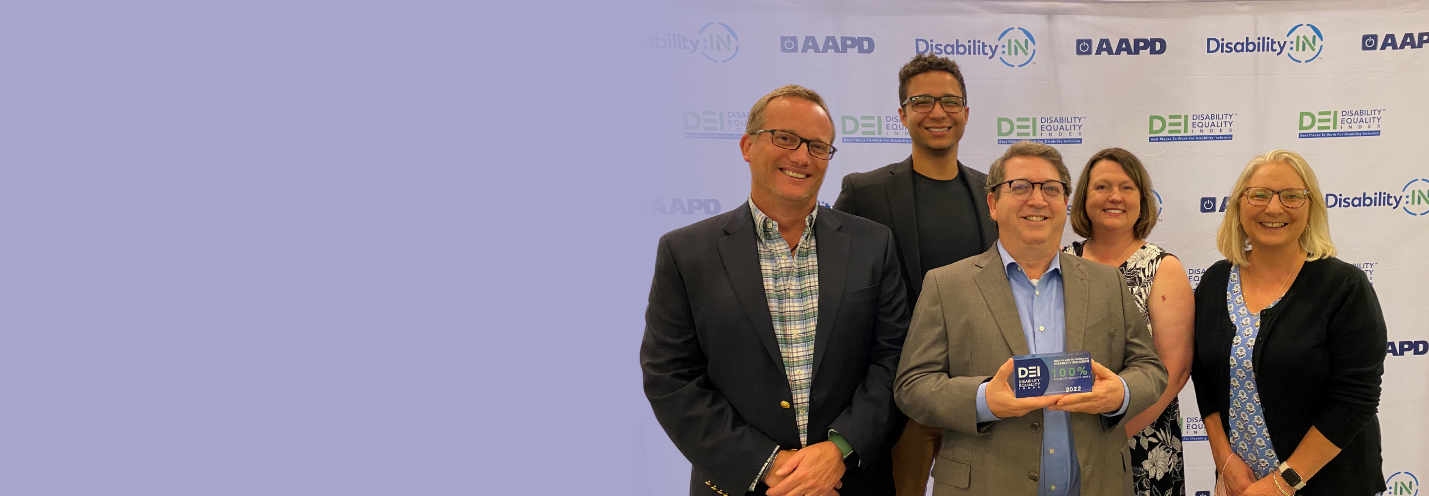 Five team members gather for a photo at the Disability:: In global conference. 