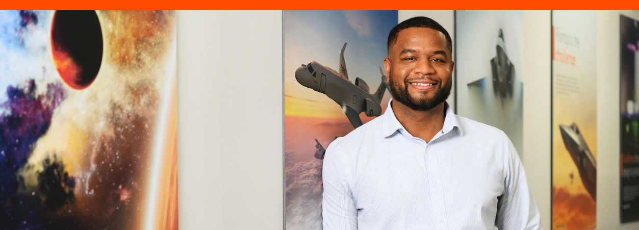 Khalid, a senior CEMA program manager at BAE Systems, smiles for a headshot.