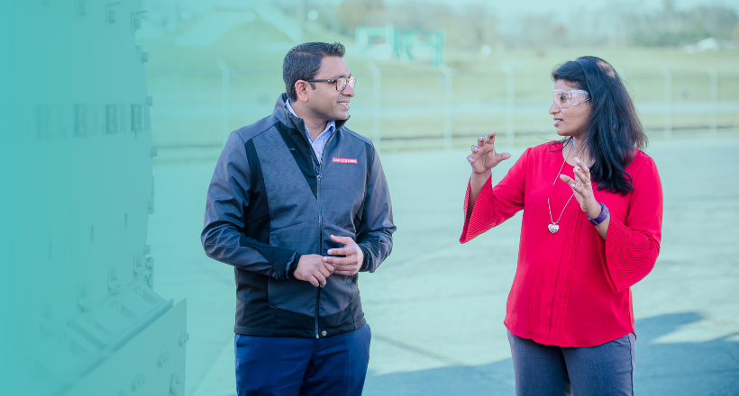 Two co-workers in platforms and services speak while at the York, PA site.