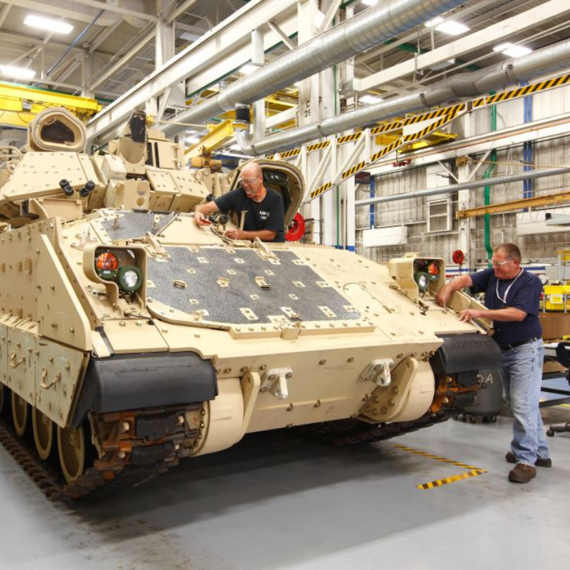 Two York employees working on a combat vehicle on the manufacturing floor.