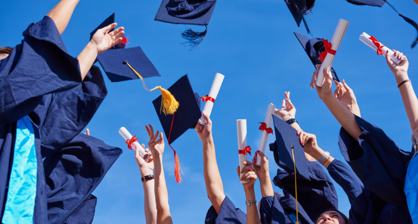 Caps and gowns being thrown in the air after graduation.