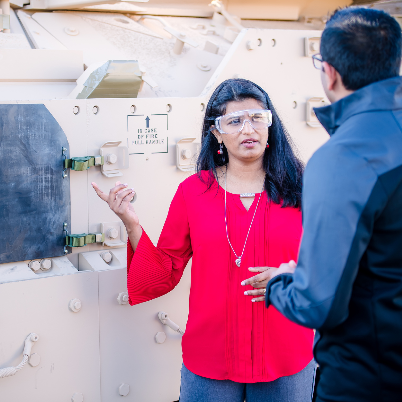 Two engineers speaking to each other.