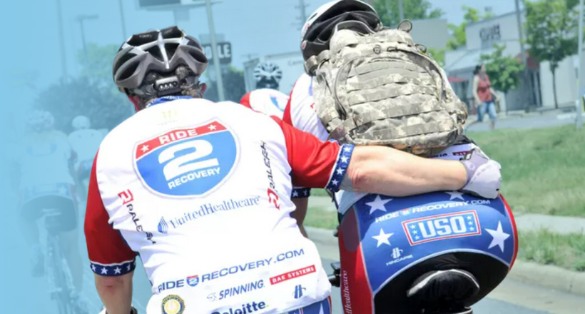 Two road bikers in a race supporting BAE Systems community investment.