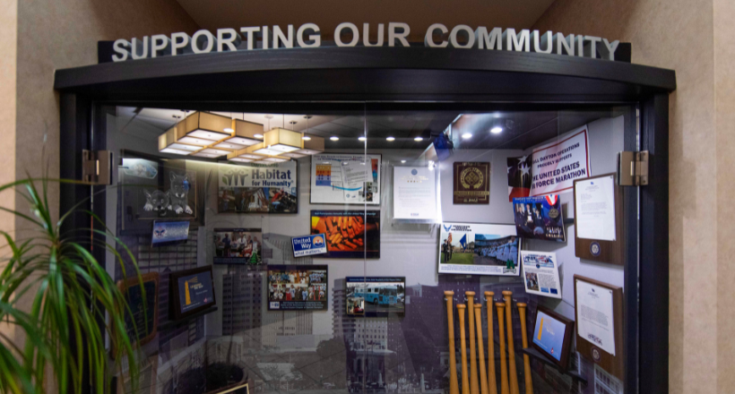 A glass case showing community investment efforts of the Dayton facility.