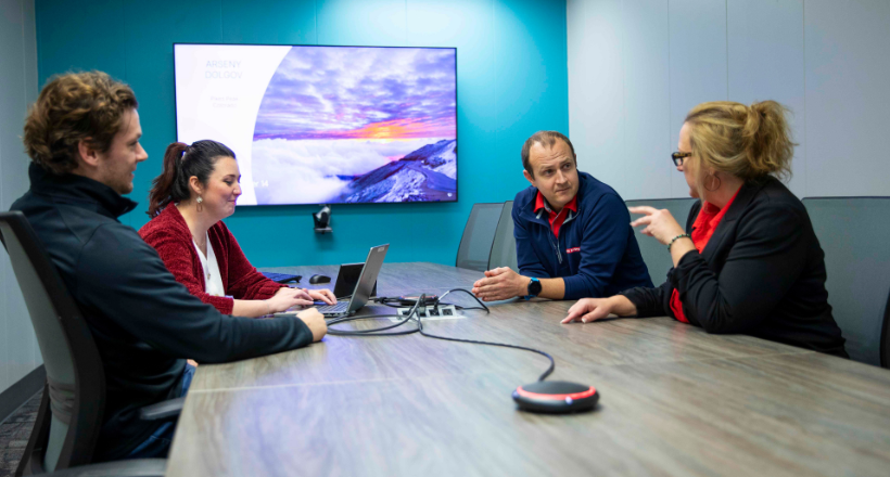 Four Dayton employees in a conference room in Dayton. 