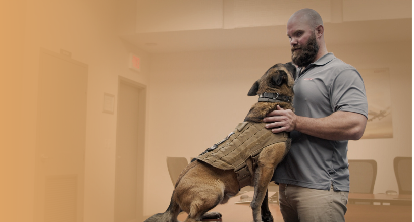 Tom, part of the Veterans' Support Network, poses for a photo with his support dog.