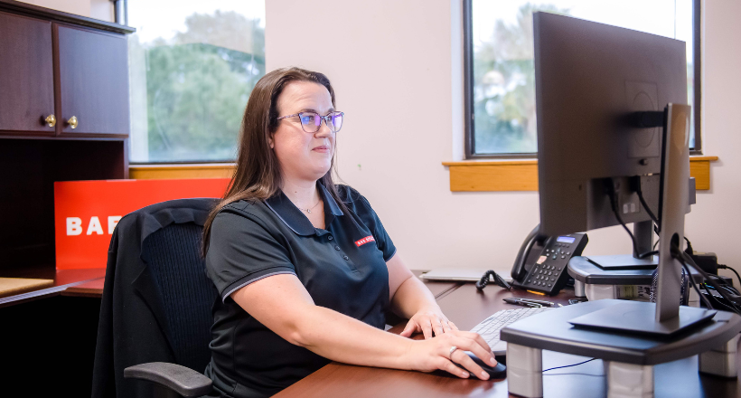 A contracts manager working in her office.