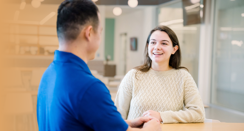 Ashley and Ryan, two electronic systems employees chat in the lunch room.