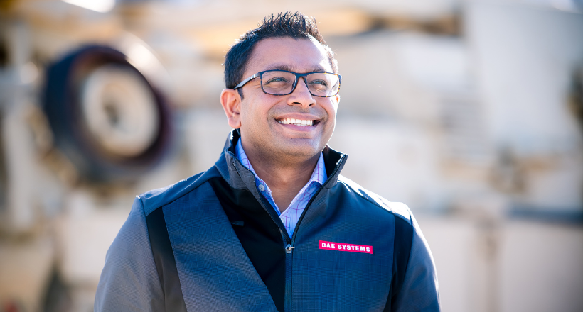 Harshit, chief of staff, walks and smiles while near the vehicle test track in York, PA.