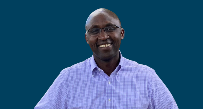 Systems engineer, Hosea, smiles for a headshot.