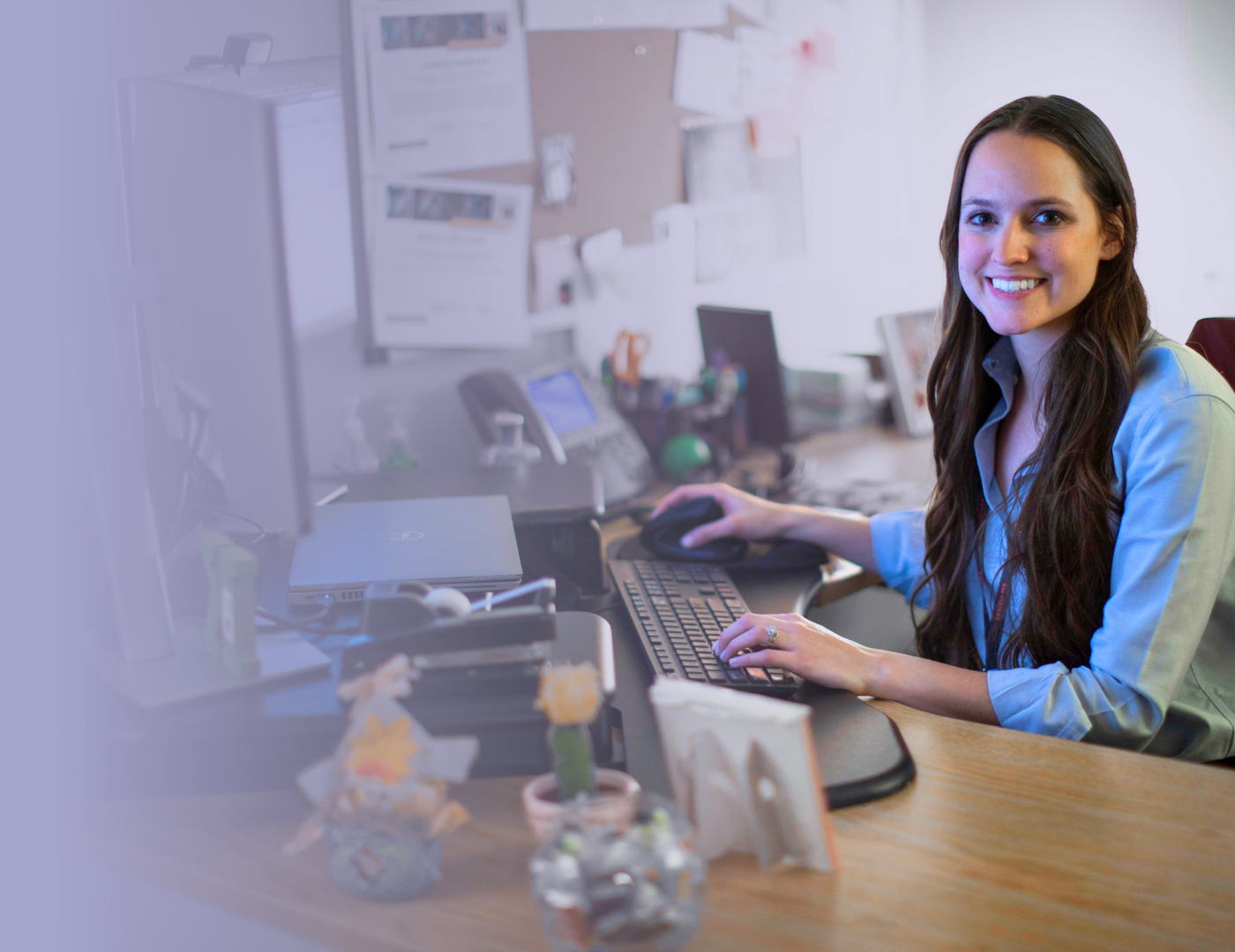 An SMS employee working at her desk.