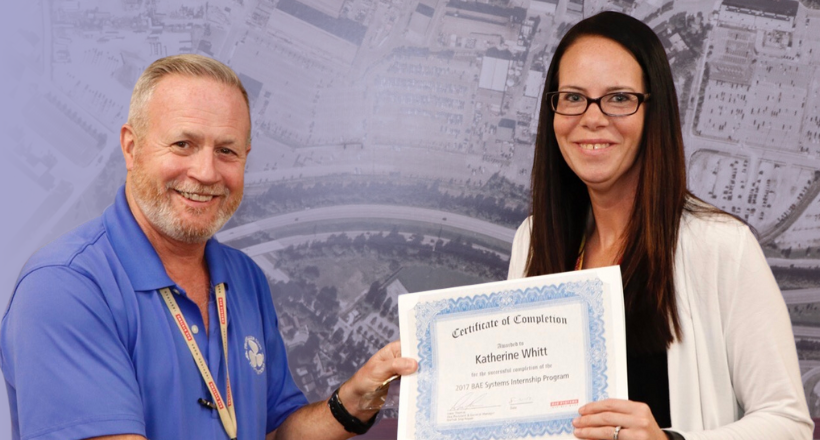 Katie Whitt being presented with her internship certificate of completion.