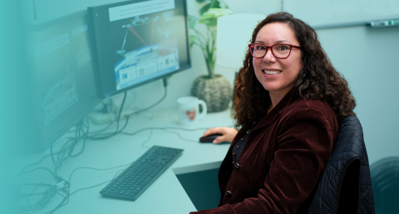 An employee from space and mission systems sector works on her desktop.