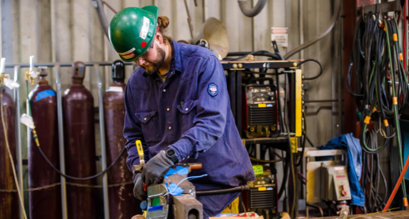 A pipefitter working in the manufacturing facility.