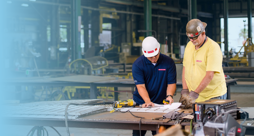 A welder and pipefitter working in the JSR ship yard.