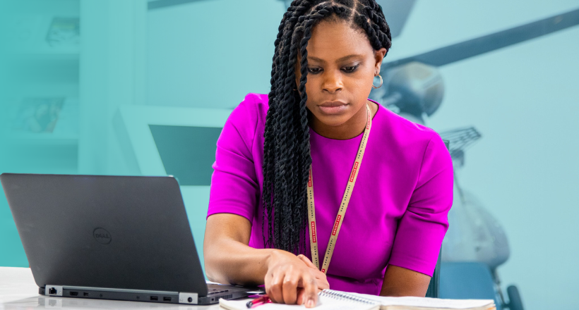 Tyece, manager of diversity, equity, and inclusion at BAE Systems studies her notebook.