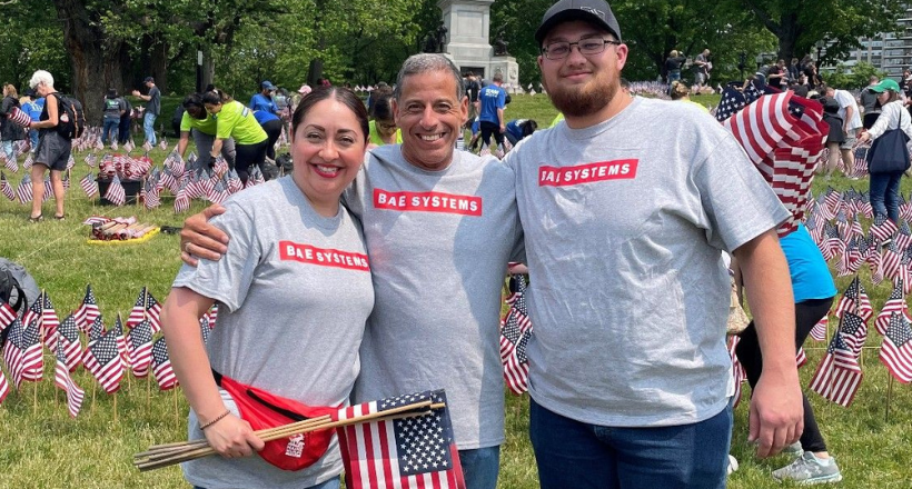 Three BAE Systems employees at a community investment event honoring our nation's troops.