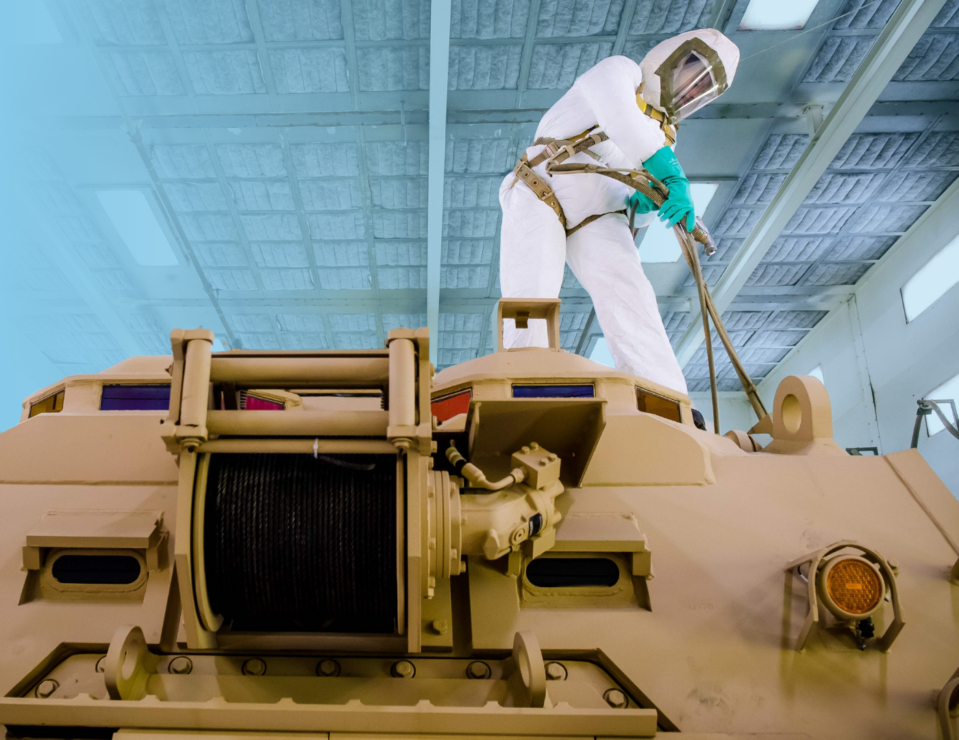 A painter at the York facility working on a combat vehicle.