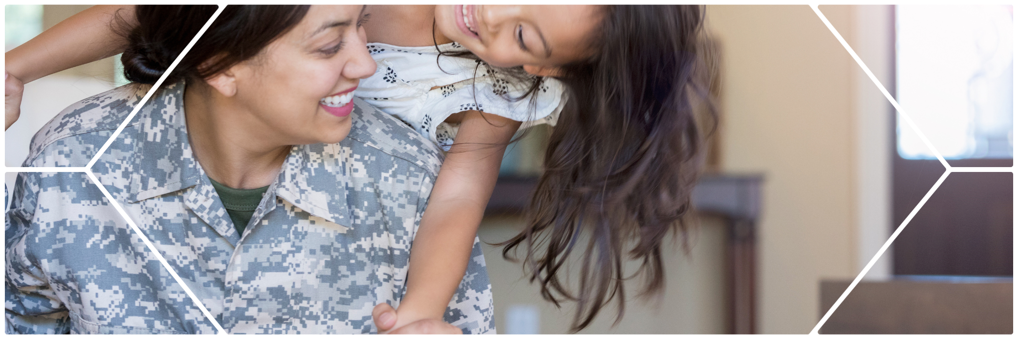 A smiling woman in a military camouflage uniform joyfully holds and plays with her young daughter, who is laughing and wearing a white dress. The moment is captured in a bright, welcoming home environment, with a geometric design overlay framing the image.