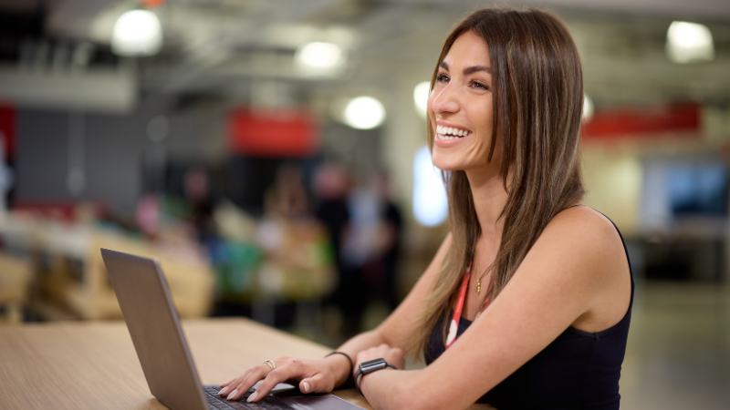 Female team member working on a laptop at the Coles SSC