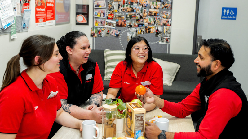 Coles team members of different cultures taking a break together in a staff room