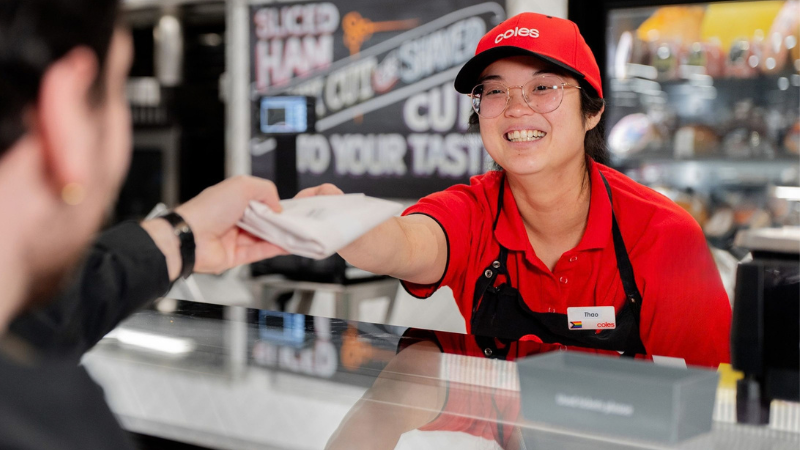 Coles team member serving a customer at the Deli checkout