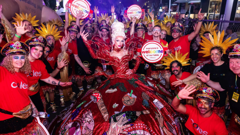m members celebrating inclusion at Mardi Gras with “Everyone Is Welcome” signs.