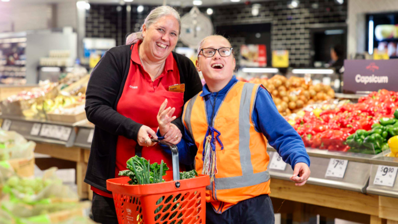 Coles team members working together, demonstrating an inclusive workplace that supports employees with accessibility requirements.