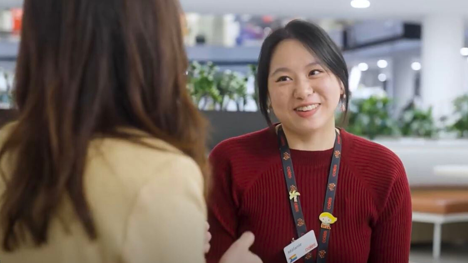 Female graduate talking to a female colleague at the Coles Store Support Centre