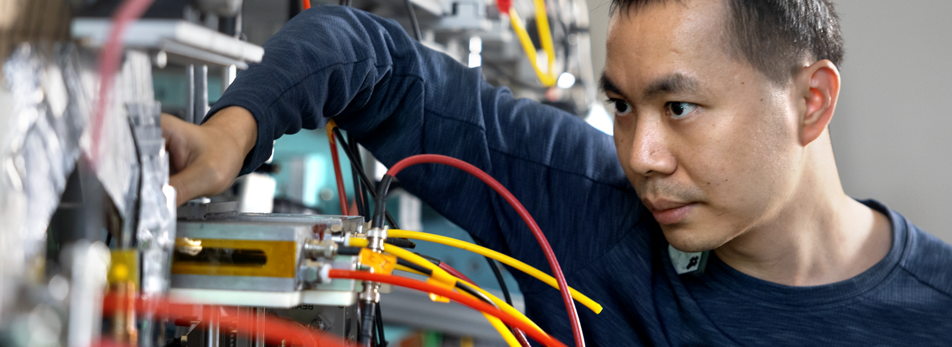 Asian man working with electronic equipment