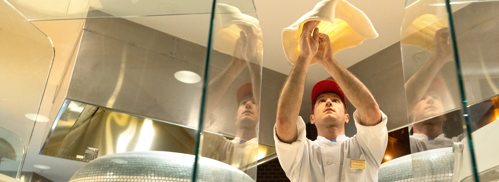 man tossing pizza dough