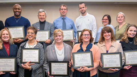 group of employees with awards certificates