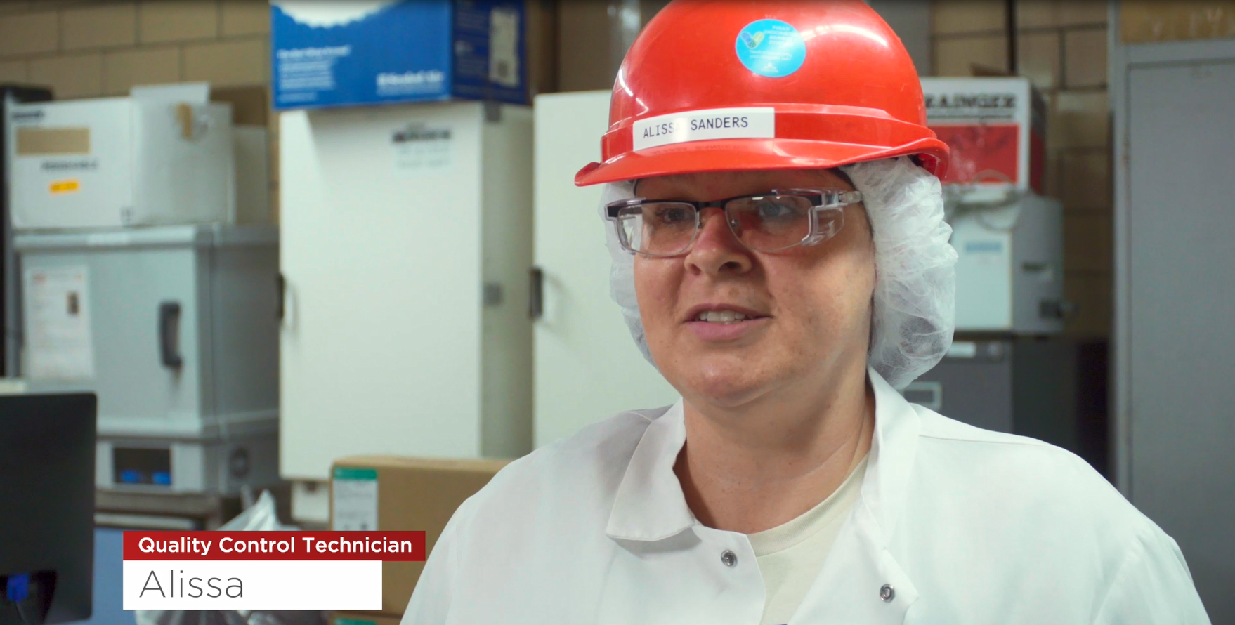 Image of Alisa at Conagra Marshall wearing a white coat and a red hard hat