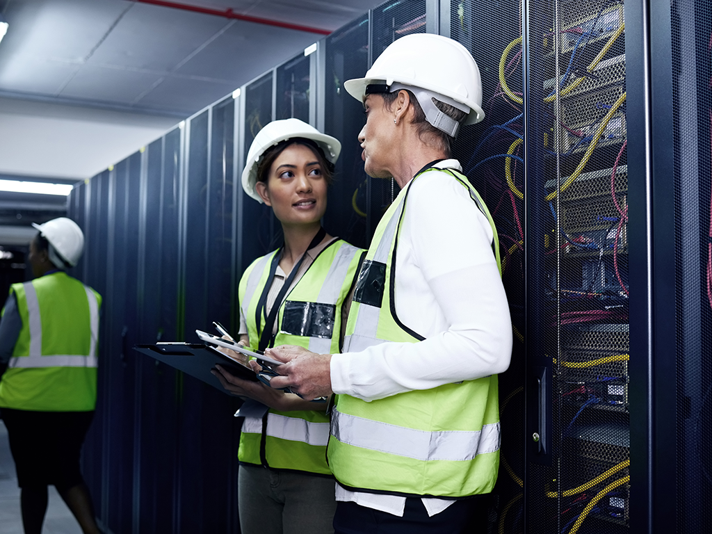 Employees with PPE equipment standing in a data center