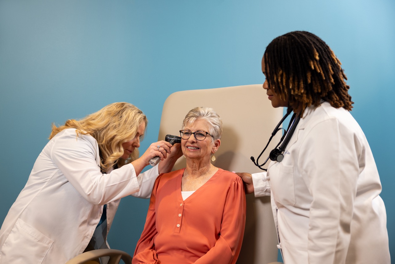 Two providers examining patient