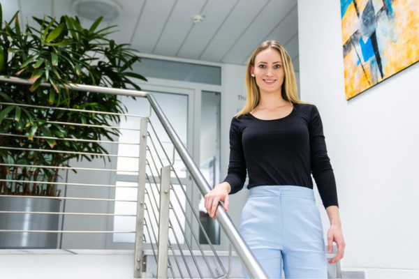 Kuehne+Nagel female employee walking down the stairs