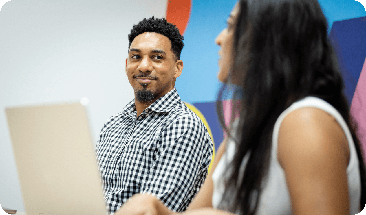 Associates smiling and talking during a meeting