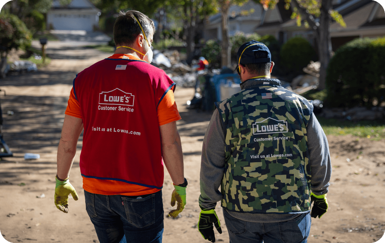 Two Lowe's associates volunteering their time to help the community rebuild after a disaster