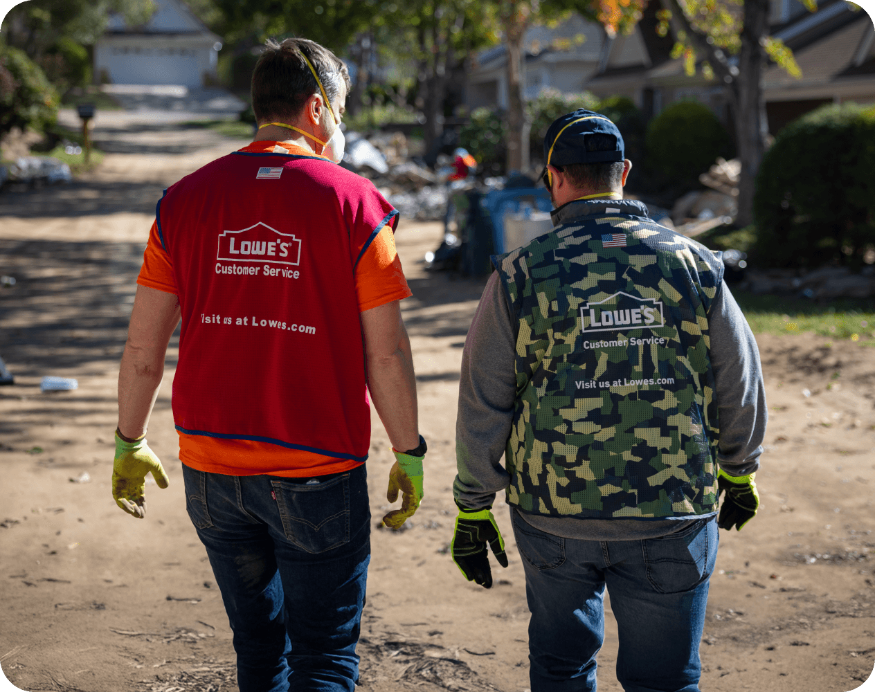 Two Lowe's associates volunteering their time to help the community rebuild after a disaster