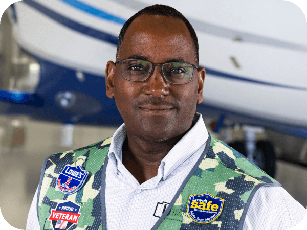 Aviation associate standing in front of a Lowe's airplane