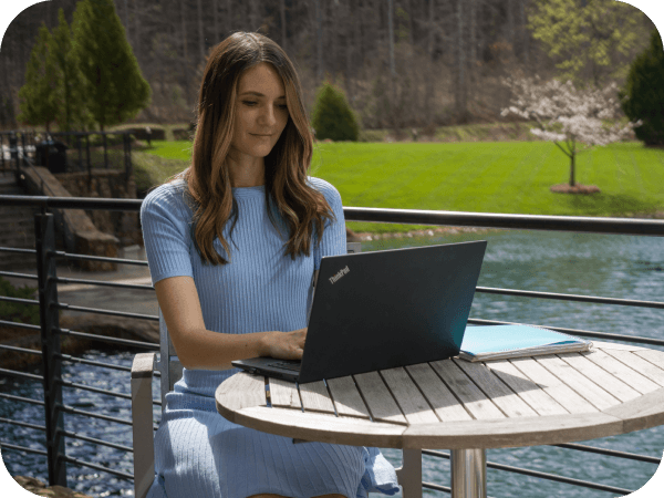 Corporate associate working on her laptop outside of headquarters