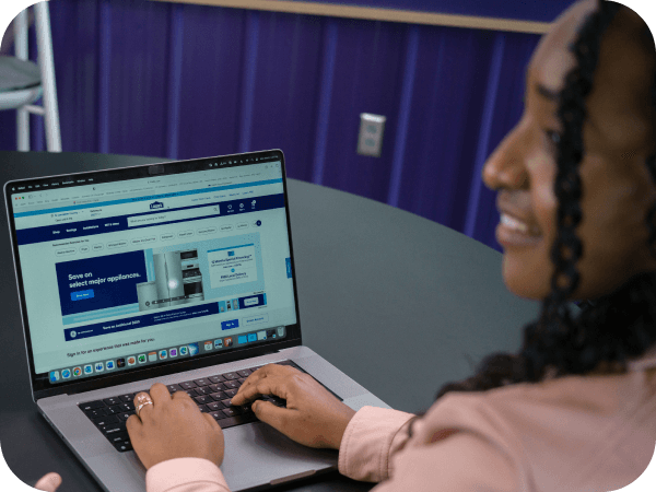 Lowe's Tech associate working on her laptop