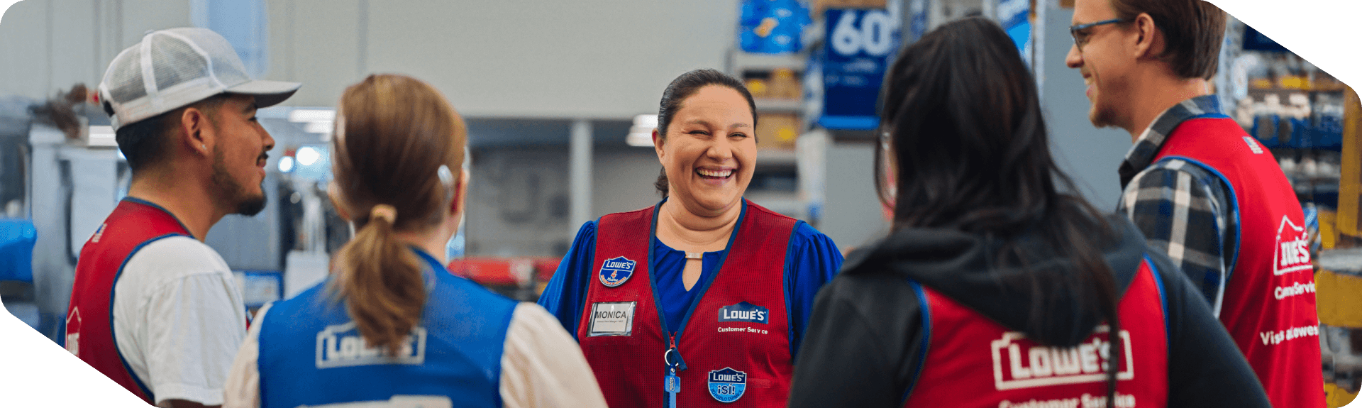 Lowe's associates smiling and laughing during a team meeting 